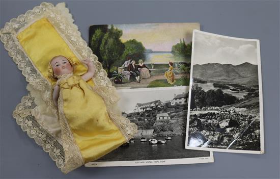 A White Five Pounds note and three £1 notes, collection of postcards and a French bisque miniature doll